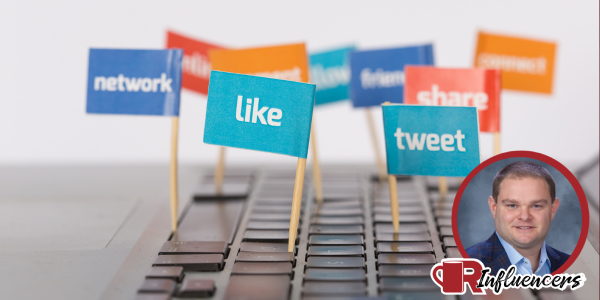 A computer keyboard with flags that read “network, like, tweet, share.” In the bottom right is Patrick Cochran’s photo