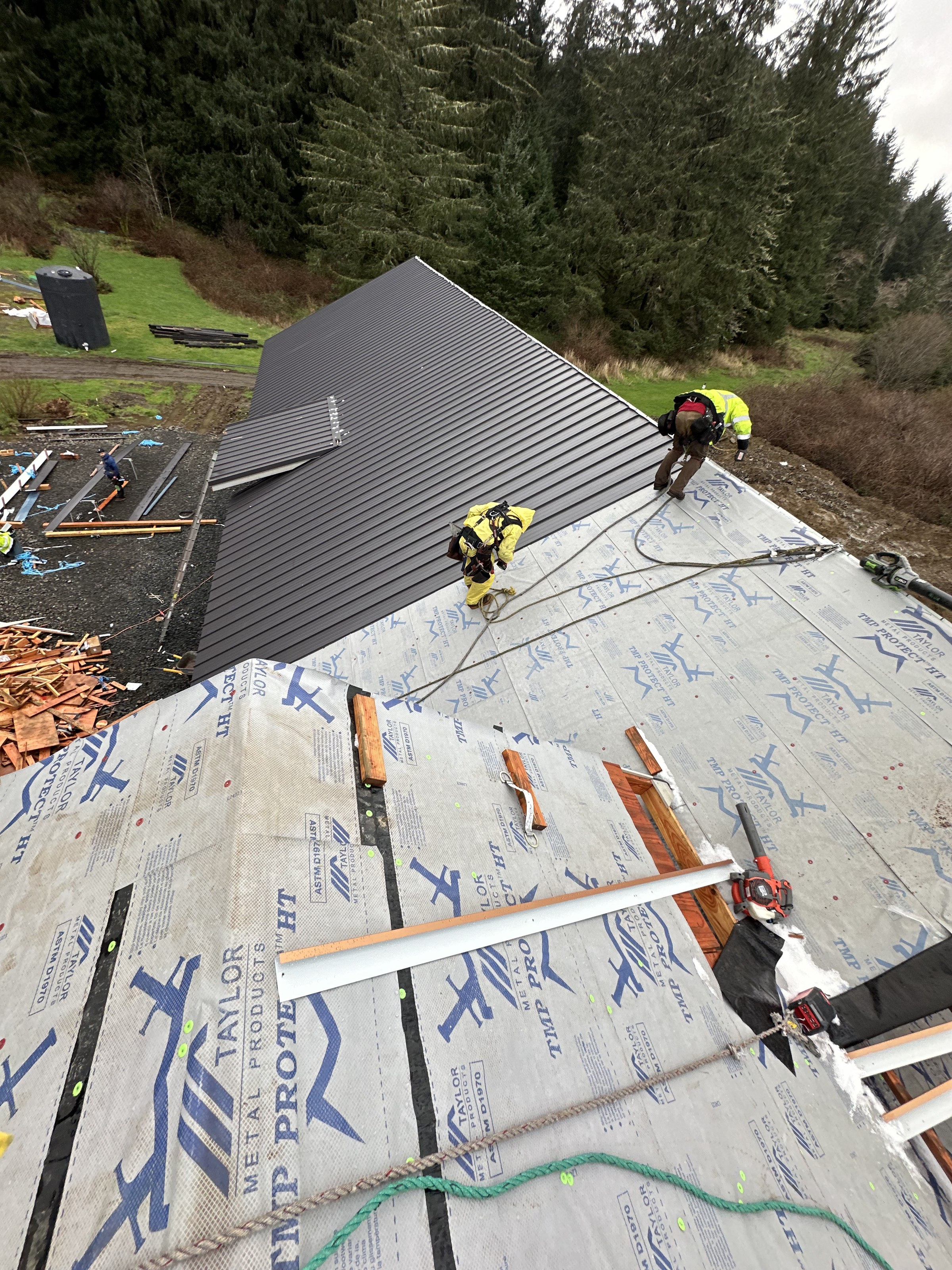 Crew working in full fall protection on a metal install